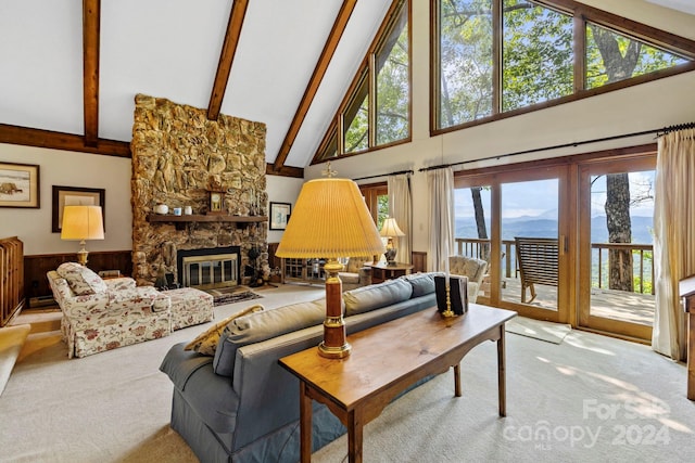 living room with light carpet, beam ceiling, a healthy amount of sunlight, and a stone fireplace