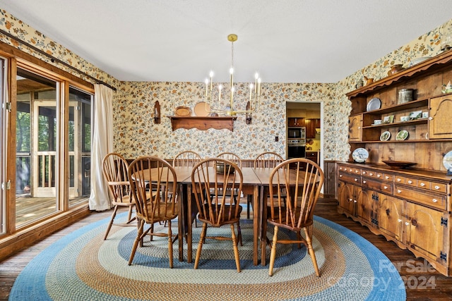 dining room with hardwood / wood-style floors and a notable chandelier