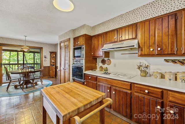 kitchen featuring decorative light fixtures, oven, white electric stovetop, light tile patterned floors, and built in microwave