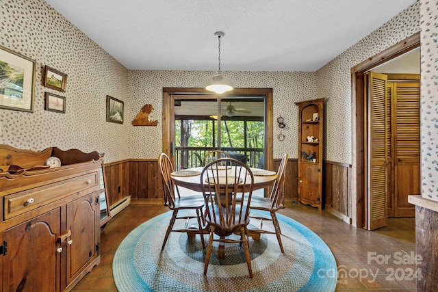 tiled dining room featuring baseboard heating