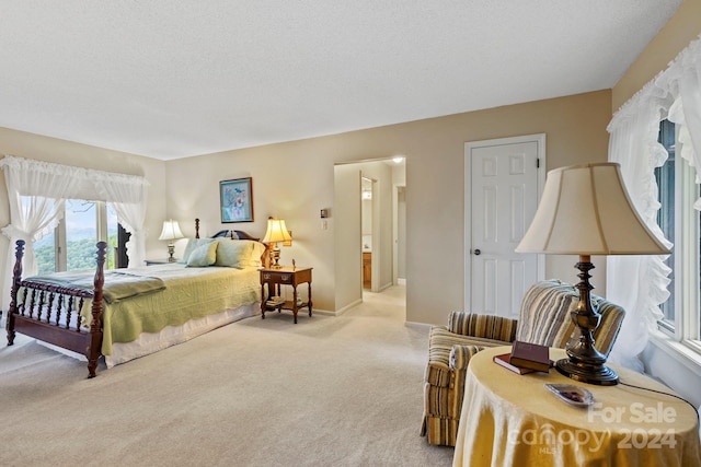 carpeted bedroom featuring a textured ceiling