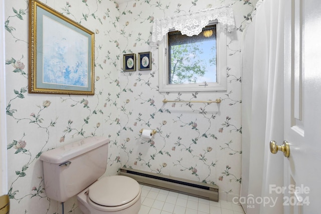 bathroom featuring tile patterned flooring, a baseboard heating unit, and toilet