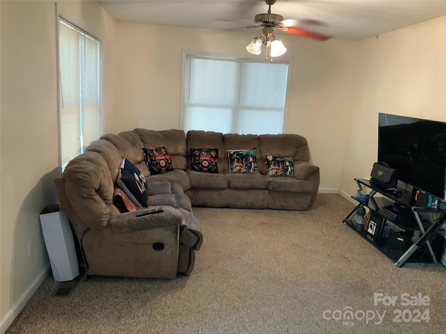 carpeted living room featuring ceiling fan