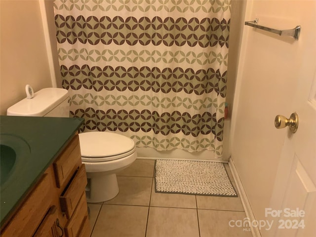 full bathroom with tile patterned flooring, vanity, toilet, and shower / bath combo with shower curtain