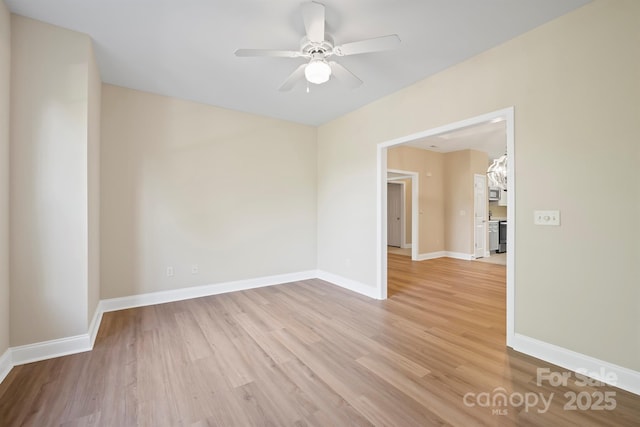 empty room with ceiling fan and light wood-type flooring