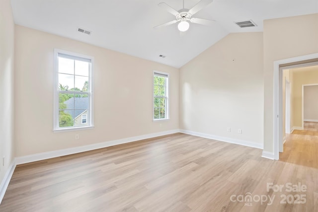 spare room featuring ceiling fan, vaulted ceiling, and light hardwood / wood-style flooring