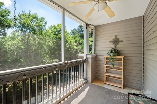 unfurnished sunroom featuring ceiling fan