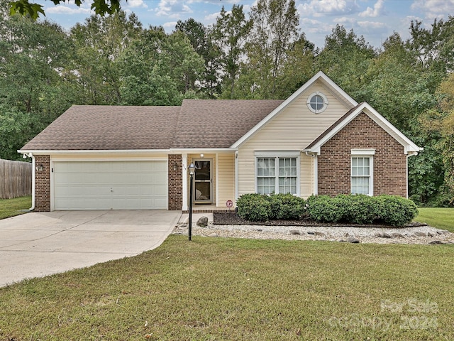 single story home featuring a front lawn and a garage