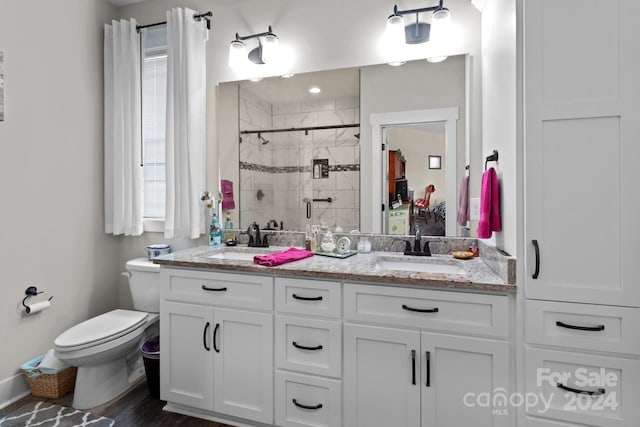 bathroom featuring toilet, a shower with shower door, hardwood / wood-style flooring, and vanity