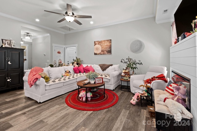 living room with ceiling fan, dark wood-type flooring, and ornamental molding