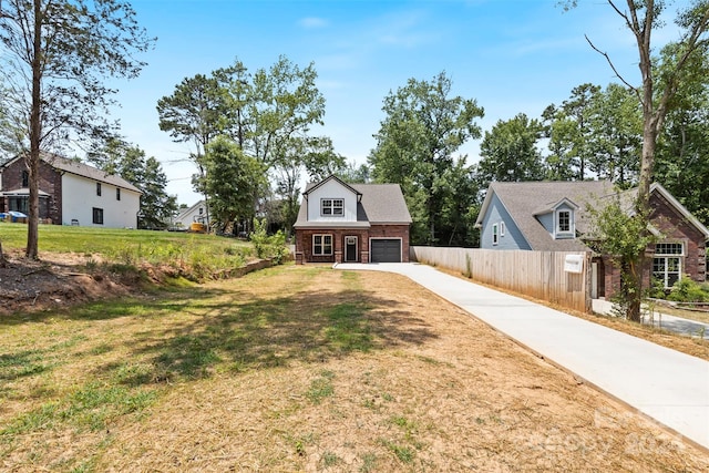 view of front of home featuring a garage and a front yard