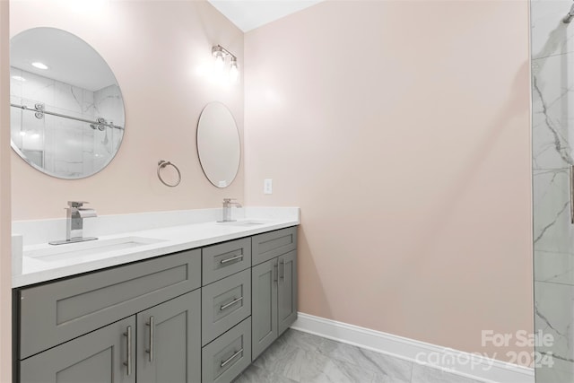 bathroom with tile patterned flooring and dual bowl vanity