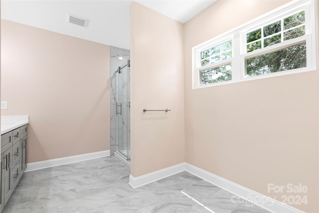 bathroom featuring vanity, tile patterned flooring, and walk in shower