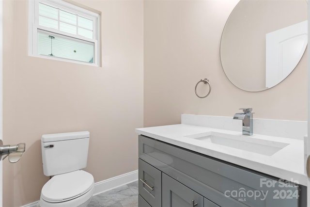 bathroom featuring tile patterned floors, vanity, and toilet