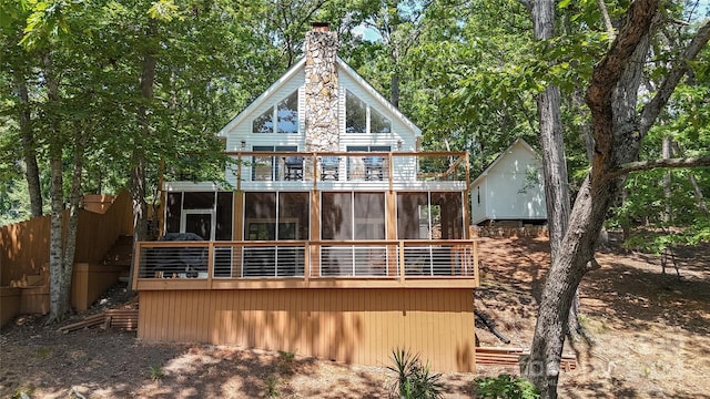 rear view of property featuring a sunroom