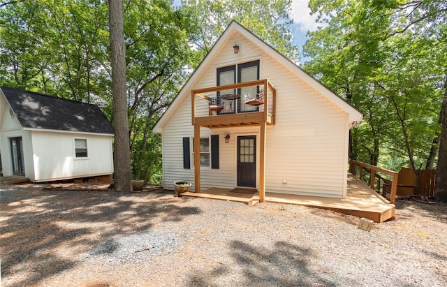 back of property featuring an outbuilding