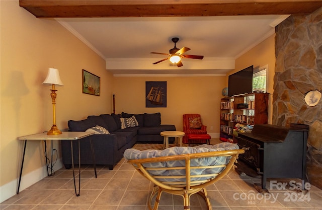 living room with ceiling fan, crown molding, and a wood stove