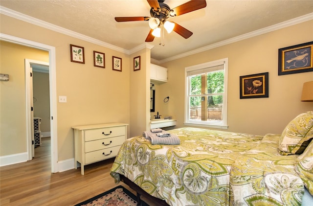 bedroom featuring a textured ceiling, ceiling fan, crown molding, and light hardwood / wood-style floors