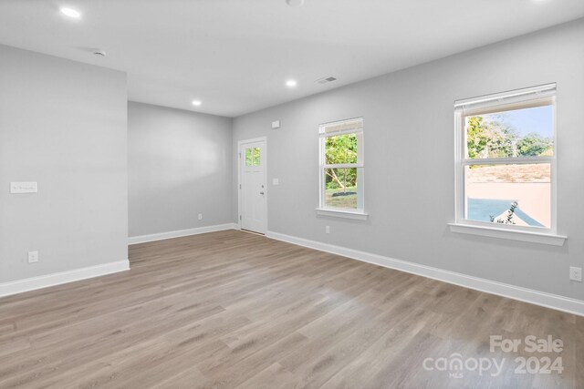 unfurnished room with light hardwood / wood-style floors