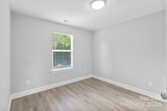 unfurnished room featuring hardwood / wood-style floors