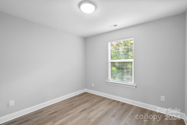 unfurnished room featuring wood-type flooring