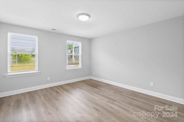 empty room with hardwood / wood-style floors