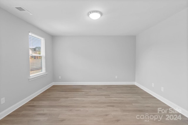 spare room with hardwood / wood-style floors