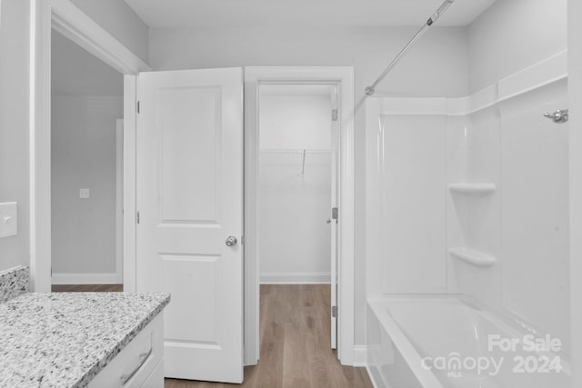 bathroom with vanity, shower / bath combination, and hardwood / wood-style floors