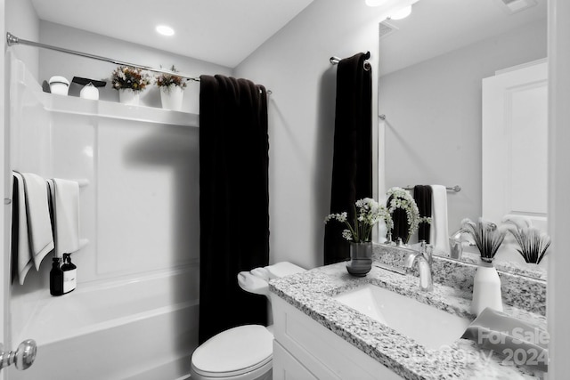 full bathroom featuring washtub / shower combination, toilet, and vanity