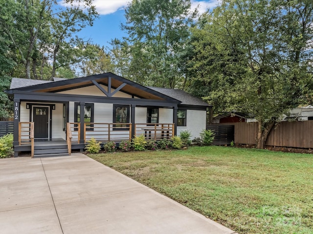 view of front of house with a front yard and covered porch