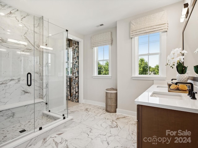 bathroom with a shower with door and vanity