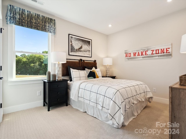 bedroom with light colored carpet