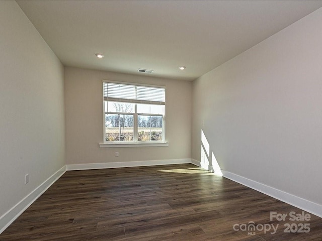 empty room featuring recessed lighting, visible vents, baseboards, and dark wood-style flooring
