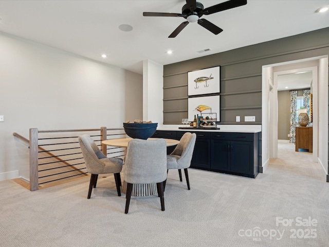 dining space with recessed lighting, light colored carpet, visible vents, and baseboards