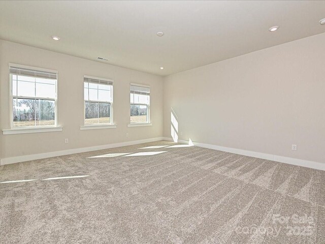 empty room with recessed lighting, baseboards, and carpet floors