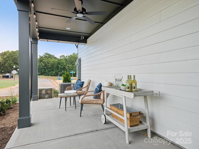 view of patio / terrace with central AC unit and ceiling fan