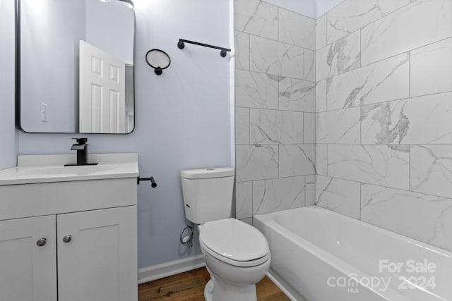 full bathroom featuring tiled shower / bath combo, vanity, toilet, and hardwood / wood-style flooring