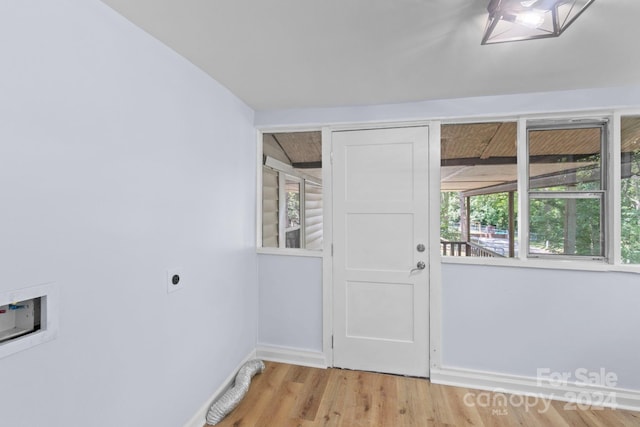 laundry area featuring hookup for a washing machine, electric dryer hookup, light hardwood / wood-style flooring, and a wealth of natural light