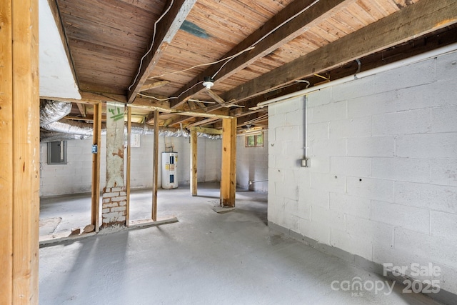 basement featuring electric panel and electric water heater