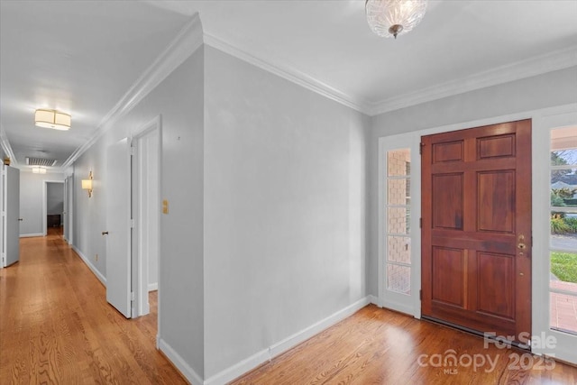 entrance foyer with crown molding and light hardwood / wood-style floors