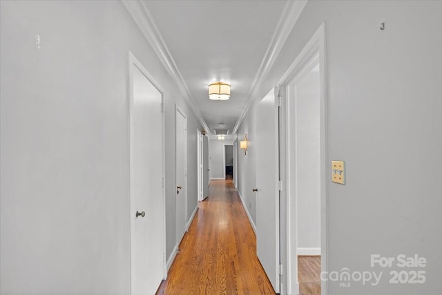 hall with crown molding and wood-type flooring