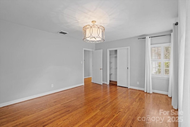 unfurnished bedroom featuring a closet and light hardwood / wood-style flooring