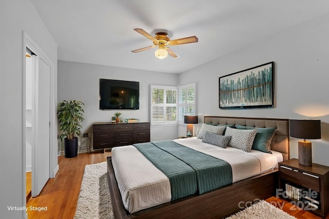 bedroom with light hardwood / wood-style floors and ceiling fan