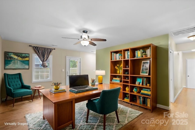 office with light hardwood / wood-style flooring and ceiling fan