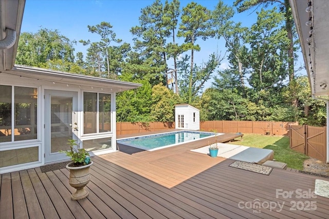 wooden terrace featuring a fenced in pool