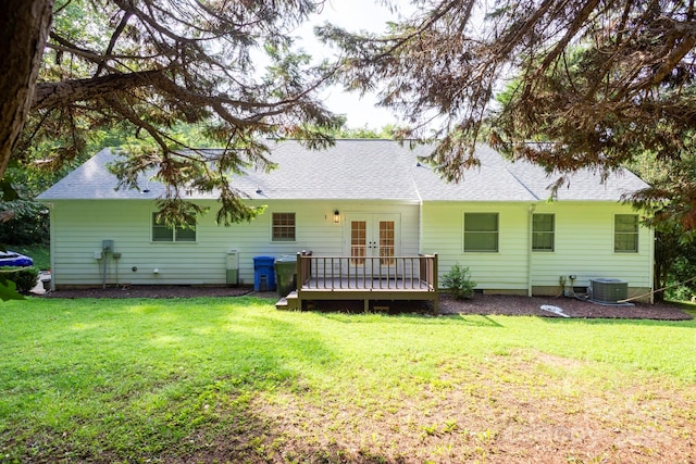 rear view of house featuring a lawn, central AC unit, french doors, and a deck