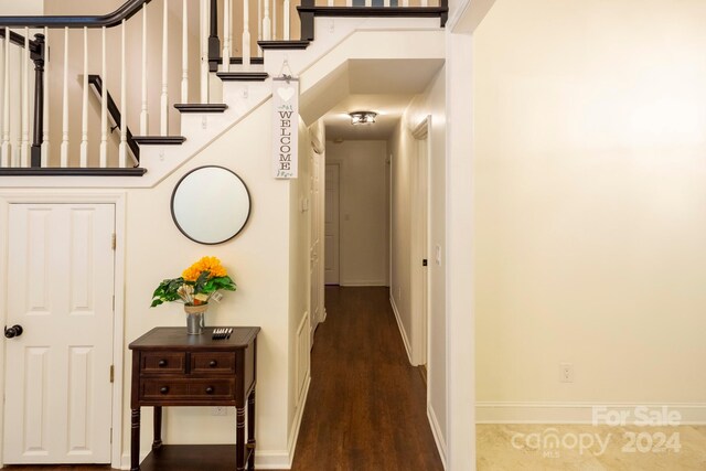 hall with dark hardwood / wood-style flooring