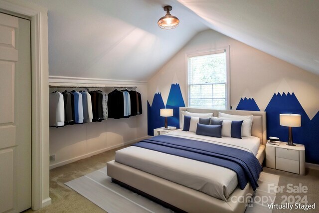 bedroom featuring lofted ceiling and light carpet