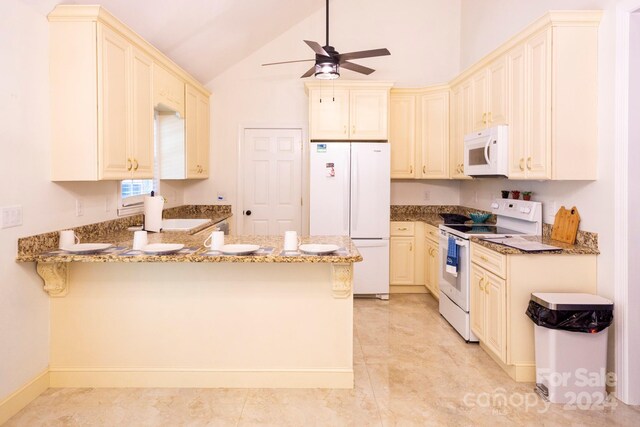 kitchen with white appliances, light stone countertops, kitchen peninsula, and vaulted ceiling