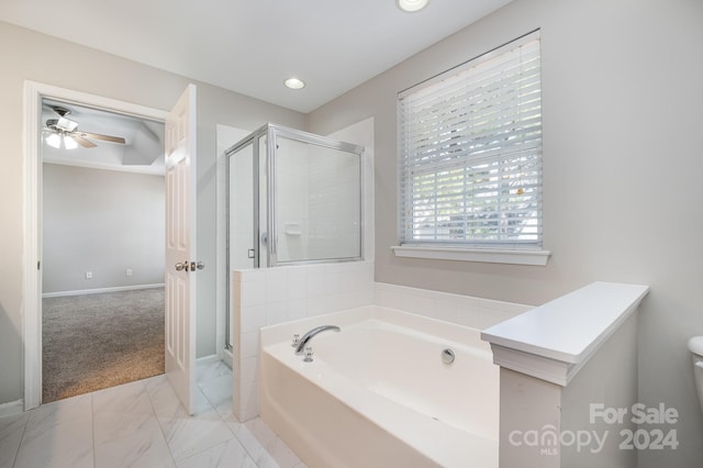 bathroom with plus walk in shower, tile patterned flooring, toilet, and ceiling fan